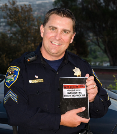 Ryan Cantrell holding a copy of his new book on human trafficking, Modern Slavery